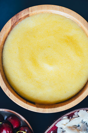 Yellow Smoothie from Banana and Pineapple in the Coconut Shell Bowlの写真素材