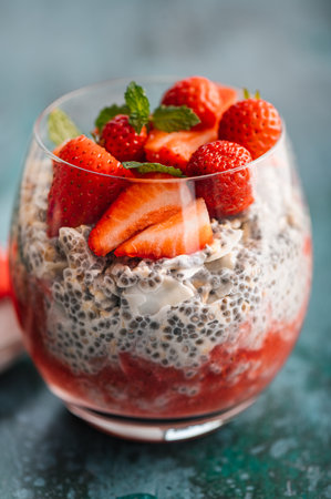 Healthy chia pudding in a glass with fresh strawberries made from almond milk and berry juice. Perfect breakfast for healthy start of the dayの写真素材