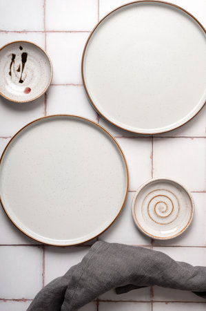 Flat lay textured ripple empty grey ceramic plate with napkin on grey background