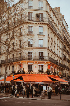 Paris, France - March 30, 2024: Parisian street and cafe full of tourists during early spring and gloomy rainy day. Toned imageのeditorial素材
