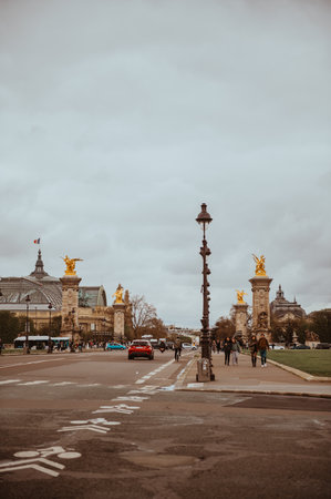 Paris, France - March 30, 2024: The Pont Alexandre III is a deck arch bridge that spans the Seine in Paris. It connects the Champs-Elysees quarter with those of the Invalides and Eiffel Tower.のeditorial素材