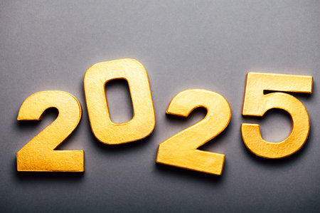 Golden digits 2025 with glitter on grey background. Holiday Party Decoration or postcard concept with top view and copy space.の写真素材