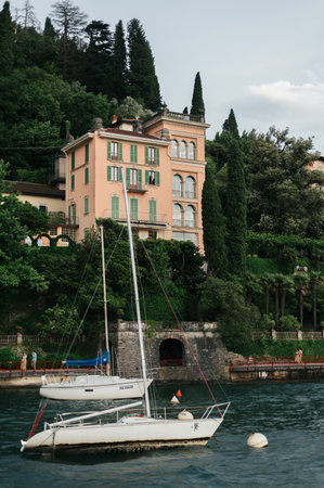 Beautiful Varenna waterfront on a sunny summer afternoon shoot during windy cloudy day, Lake Como, Lombardy, Italyの写真素材