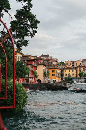 Beautiful Varenna waterfront on a sunny summer afternoon shoot during windy cloudy day, Lake Como, Lombardy, Italyの写真素材