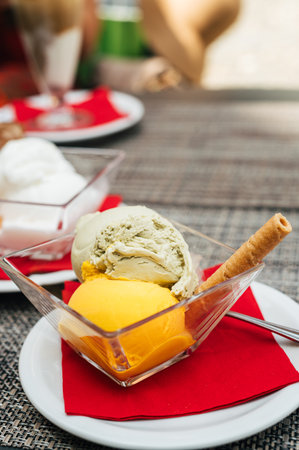 Italian coffee break in cafe during holiday season with pistachio and mango gelatoの写真素材