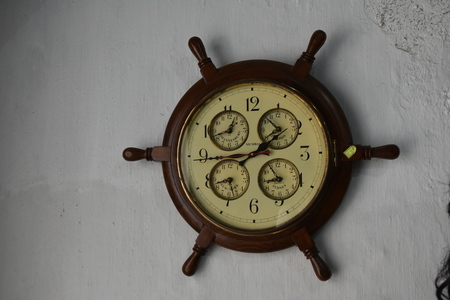 Antique wall clock showing four different timing