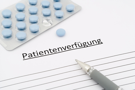 living will in german with blue pills ans grey penの写真素材