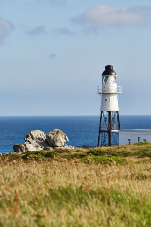 Isles of Scilly, United Kingdom - Peninnis Lighthouse on a sunny autumn day with rocks and sea and...