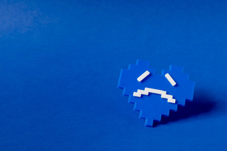 Blue monday concept, which represents the saddest day of the year. Made with a small blue heart with a sad face.の写真素材