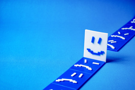 Concept of a happy face around sad and angry faces.の写真素材