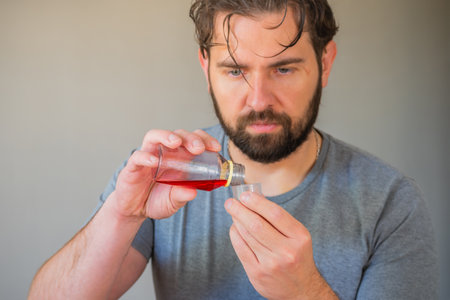 Person pouring syrup into a measuring cup.の写真素材