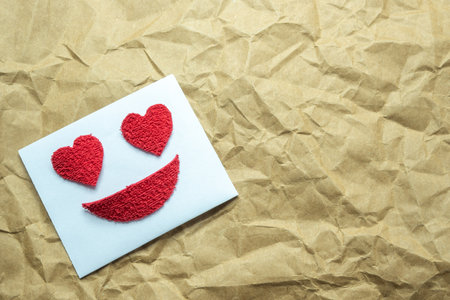 Letter with a smiley face and heart eyes.の写真素材