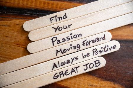 Concept of motivational words on ice cream sticks on a table.