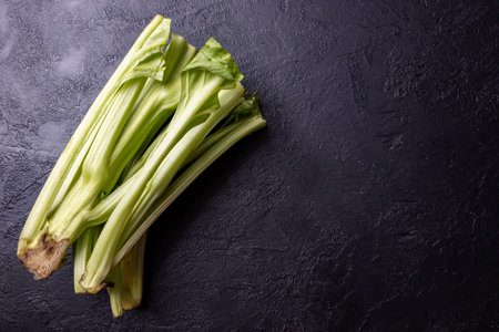 Chard stems on a dark background.