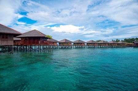 Exotic tropical resort in the middle of ocean on crystal clear waterの写真素材