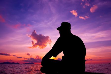 A tourist waits for the sunrise during travel to Malaysia Borneo Region of Sabah Mabul Semporna islandの写真素材