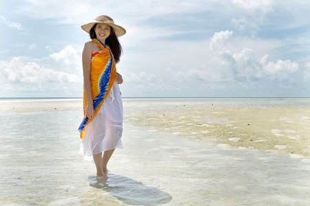 Asian pretty girl during holiday at beautiful oceanの写真素材