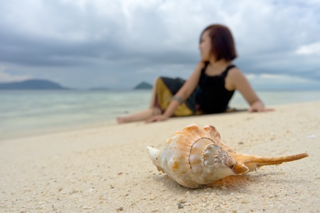 Close-up shell crab in front of pretty teenの写真素材