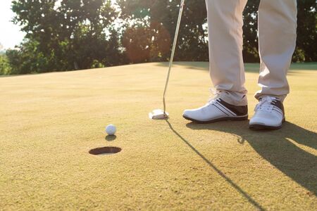 close up of golfer putting on the greenの写真素材