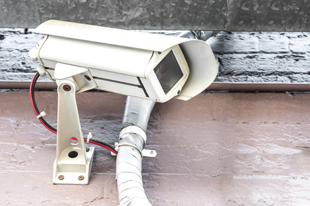 a dirty  CCTV on the old wall