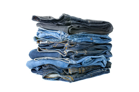 Lot of blue jeans isolated on white background