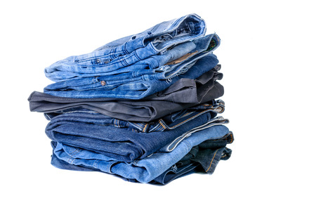 Lot of blue jeans isolated on white backgroundの写真素材