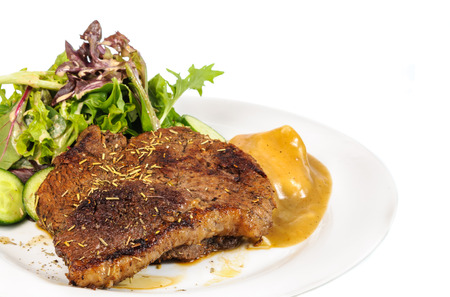 Rump steak with mashed potatoes and mix vegetable on plate isolated on white backgroundの写真素材