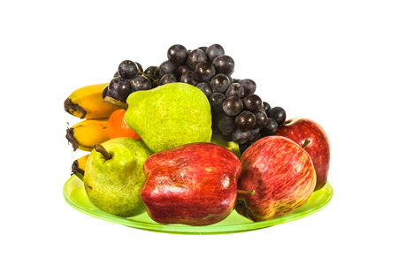 Mix fruit on green plate isolated on white backgroundの写真素材