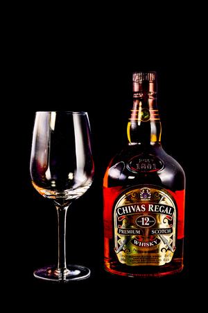 SYDNEY, AUSTRALIA - February 9, 2016: Bottle of Chivas Regal on black background, Chivas Regal  Blended Scotch Whisky aged twelve years. Chivas Regal is a premium Blended Scotch Whisky produced by Chivas Brothers since 1801のeditorial素材