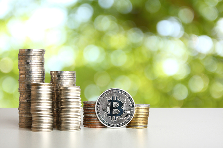Silver coins placed on a white table. Green backdropの写真素材
