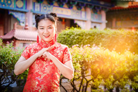 Asian women wearing red cheongsams to congratulate the Chinese New Year. New Year Celebration 2020