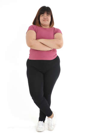 Fat Asian woman standing and posing as her arms crossed on a white background in the studio. Weight loss exercise conceptの写真素材
