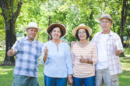 Asian male and female seniors Happy life after retirement Thumbs up. Pleasing. The concept of an elderly community.の写真素材