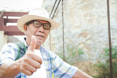 Senior man backpacking hiking Nature travel He is healthy. The concept of a happy life after retirement . Copy spaceの写真素材