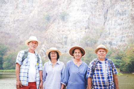 A group of Asian seniors hiking and standing on high mountains enjoying nature. Senior community conceptsの写真素材