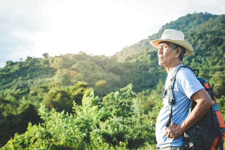Senior man backpacking hiking Nature travel He is healthy. The concept of a happy life after...
