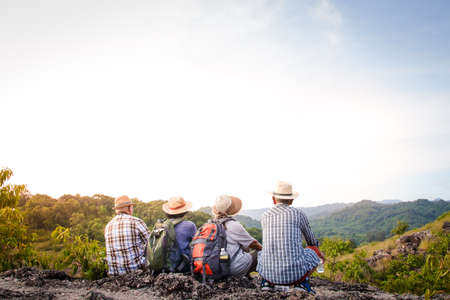 A group of Asian seniors hiking and standing on high mountains enjoying nature. Senior community conceptsの写真素材