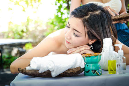 A beautiful Asian woman doing spa with massage. Makes the skin look younger And resulting in firmer skin. Concept Beauty and relaxation Physical and mental health.の写真素材