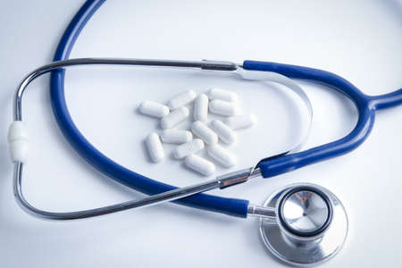 Medicines and medical stethoscope placed on a white background. Patient treatment conceptの写真素材