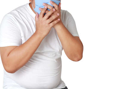 Asian fat man wears a blue cloth mask to cover his mouth and nose to protect against germs and the...