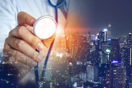 Doctors use stethoscope to check their health in big cities. Many people are at risk of spreading coronavirus. Concepts of treatment for viruses, life threatening diseases. copy spaceの写真素材
