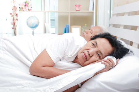 An elderly woman in bed with a lover She has stress, discomfort. Insomnia is sick. Health care conceptの写真素材