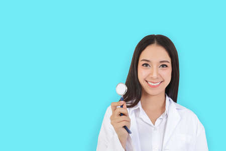 Asian female physicians hold stethoscope to check the health of patients. copy space, Green background,  , isolatedの写真素材