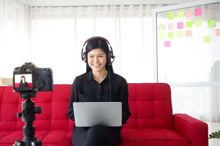 A beautiful Asian teacher taught online using a camera to record live events on the internet for students studying at home. New educational concepts, social distance, coronavirus protectionの写真素材