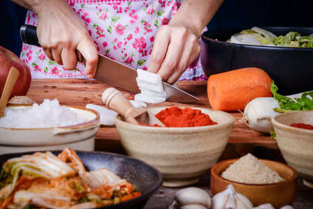 Housewife cooking Chop the radishes and carrots mixed with Chinese cabbage to make kimchi. Korean food conceptの写真素材