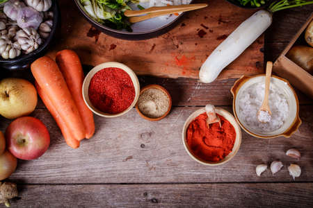 Korean kimchi pickles ingredients There are radishes, carrots, Chinese cabbage, apples, onions, garlic, salt, peppers, Gochujang. Fermented food concept. Top viewの写真素材
