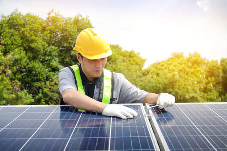 Asian technicians install panels Solar cells to produce and distribute electricity. Energy technology conceptの写真素材