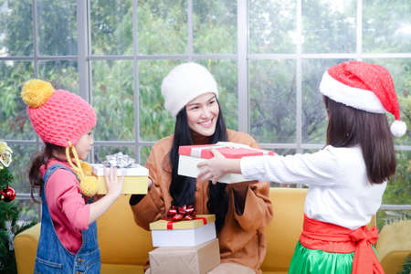 The two lovely girls are happy that the beautiful sisters give presents at Christmas. They are happy...