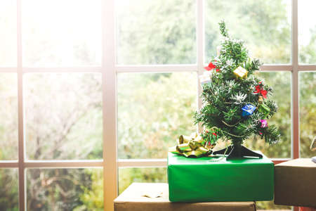 Happy new year concept of bauble decoration hanging on a Christmas tree. With many gifts placed in...