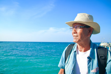 Elderly man wearing a hat Happy to travelの写真素材